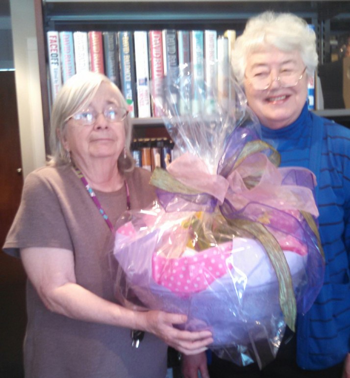 Director of Pine Plains Library Marguerite Hill and Coordinator of Volunteers Rae Hart accept a gift from the FRIENDS of the Pine Plains Library in honor of National Library Workers Day