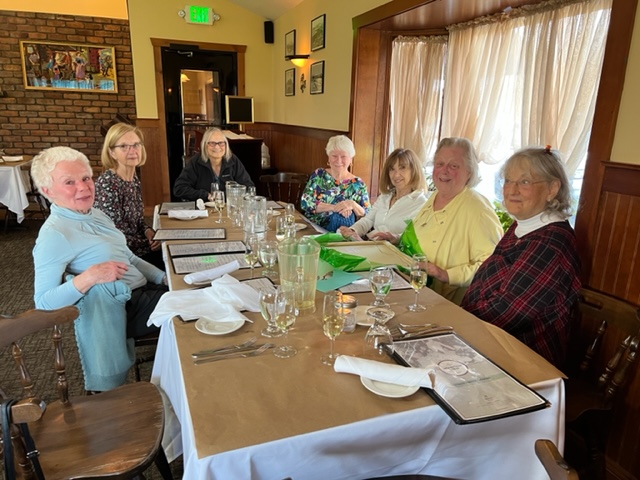 This image has an empty alt attribute; its file name is janet-and-table.jpg